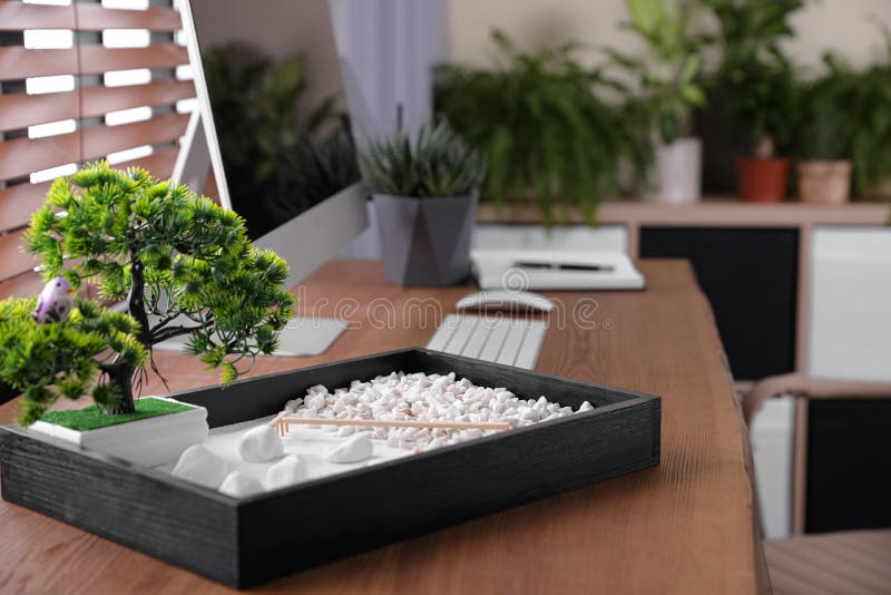 Beautiful Miniature Zen Garden and Computer on Table in Office Stock
