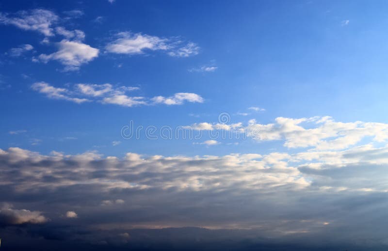 Beautiful mixed white and dark cloud formations on a blue sky