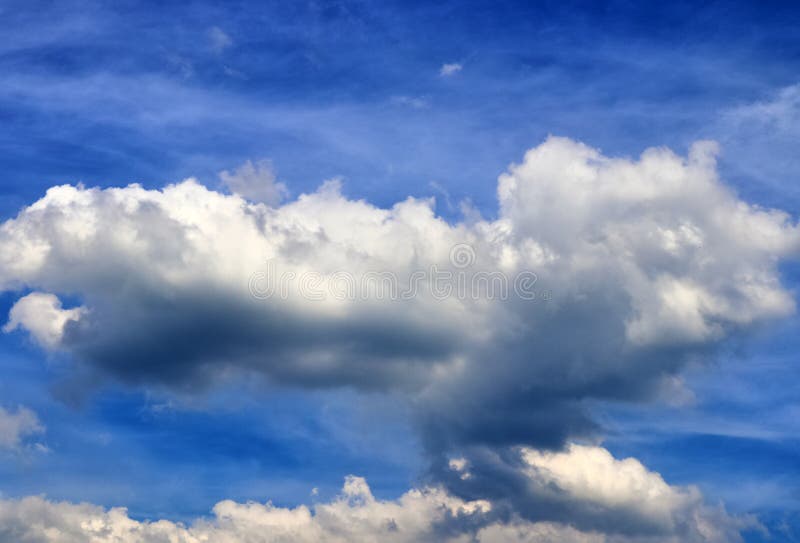 Beautiful mixed white and dark cloud formations on a blue sky