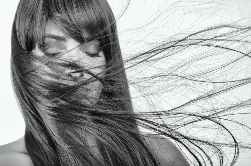 Beautiful model girl with healthy shiny long hairs waving aside