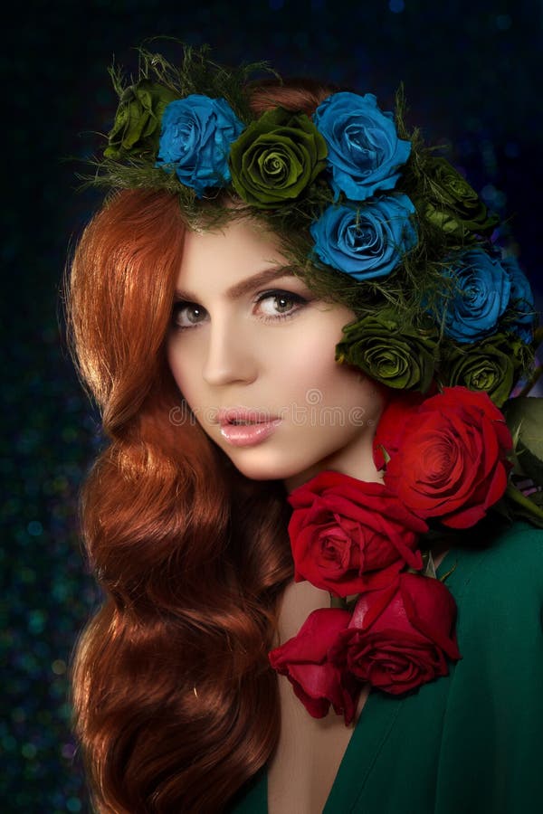 Beautiful model woman with blue, green and redrose flower in hair, beauty salon makeup. Young girl from a fairy tale royalty free stock photo Beautiful model woman with blue, green and redrose flower in hair, beauty salon makeup. Young girl from a fairy tale royalty free stock photo