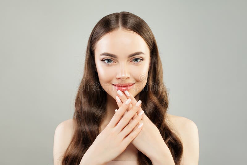 Beautiful model woman showing hand with manicured nails. Skincare and manicure concept