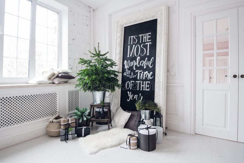 Beautiful modern design of the room in delicate light colors decorated with Christmas tree and decorative elements