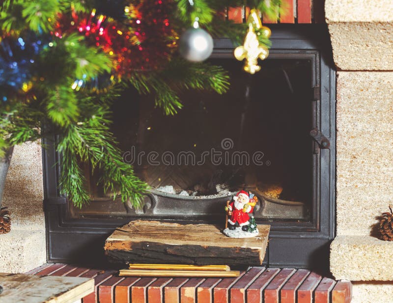 Figurine Santa Claus Standing on Logs in Front of Fireplace Stock Image ...