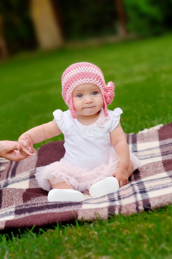 Beautiful 4 month old baby girl in pink flower hat and tutu