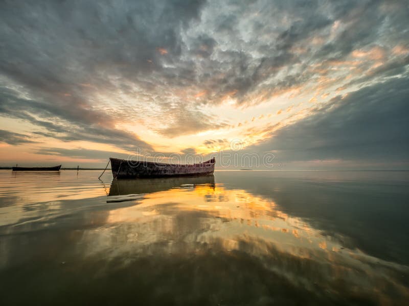 Beautiful morning landscape with boats on the lake at the sunrise