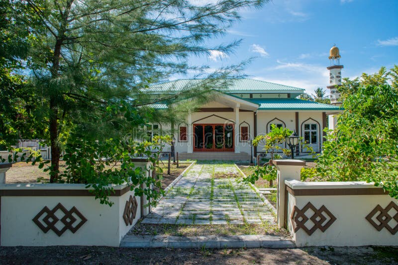 Beautiful mosque with garden and fence in the village at tropical island stock photo Beautiful mosque with garden and fence in the village at tropical island stock photo