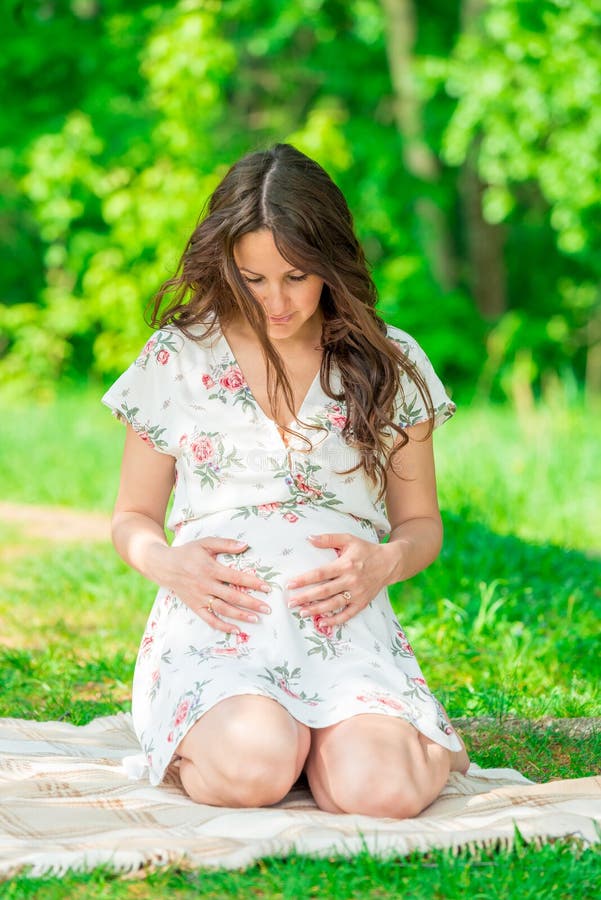 beautiful mother in anticipation of a child, shooting in a summer park royalty free stock photos beautiful mother in anticipation of a child, shooting in a summer park royalty free stock photos