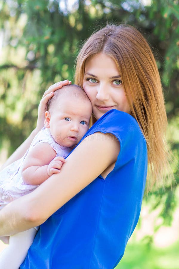 Beautiful mother and baby outdoor.