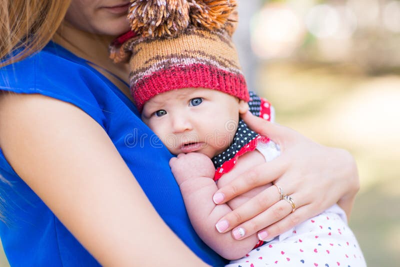 Beautiful mother and baby outdoor.