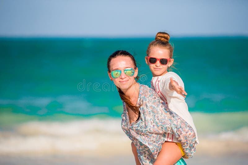 Beautiful Mother And Daughter At Caribbean Beach Enjoying Summer 