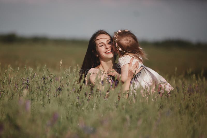 Beautiful Mother And her little daughter outdoors. Nature. Outdoor Portrait of happy family. Happy Mother`s Day Joy