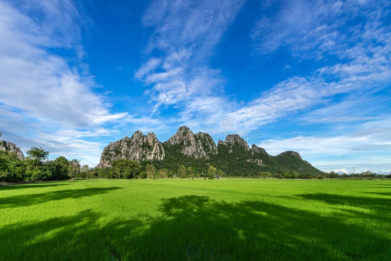 Beautiful mountain on blue sky background , rice fields Foreground , Nakhon Sawan province , North of thailand