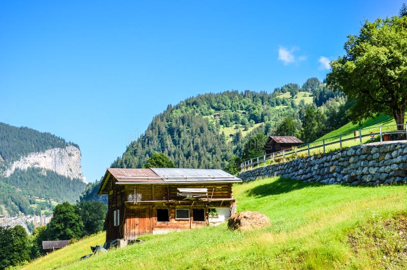 Beautiful mountain hut near Lauterbrunnen in Swiss Alps. Stunning Alpine landscape in summer season. Sunny day, green hills. royalty free stock photography Beautiful mountain hut near Lauterbrunnen in Swiss Alps. Stunning Alpine landscape in summer season. Sunny day, green hills. royalty free stock photography