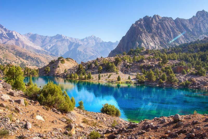 Beautiful mountain nature landscape on sunny summer day. Alaudin lake in Fann mountains, Tajikistan. Scenic with on blue water in stock photos Beautiful mountain nature landscape on sunny summer day. Alaudin lake in Fann mountains, Tajikistan. Scenic with on blue water in stock photos