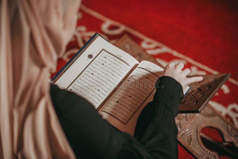 Image of A,Woman,Reading,The,Quran,On,A,Prayer,Rug-SF790574-Picxy