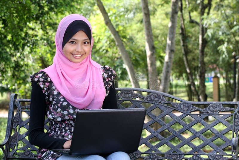 Beautiful muslim woman using laptop