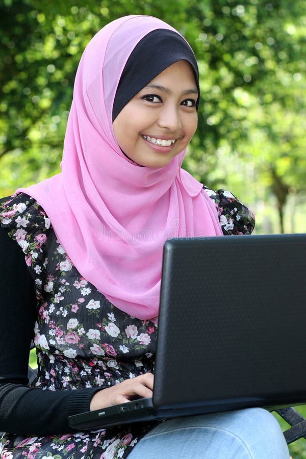 Beautiful muslim woman using laptop