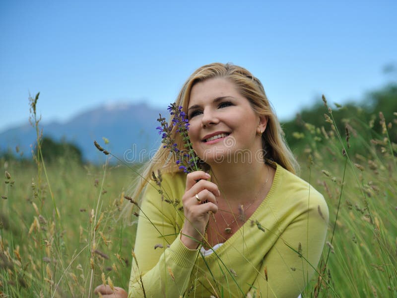 Beautiful natural woman outdoors in a field