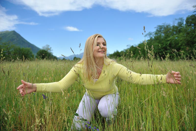 Beautiful natural woman outdoors on a field