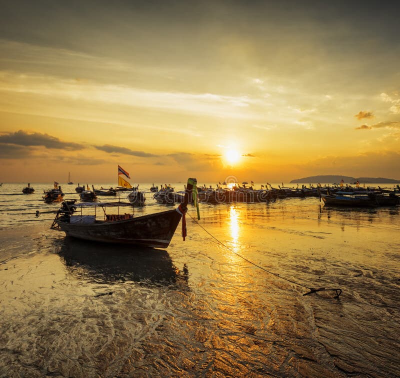 Traditional thai boats at sunset beach