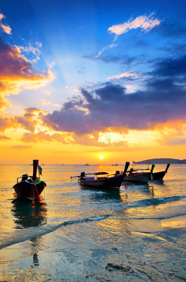 Traditional thai boats at sunset beach