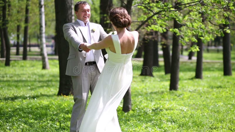 Beautiful newly married couple turn around holding stock footage