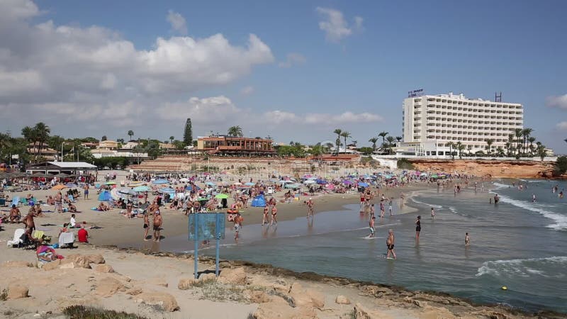 La Zenia Spain beautiful beach with people in the sea in the sunshine