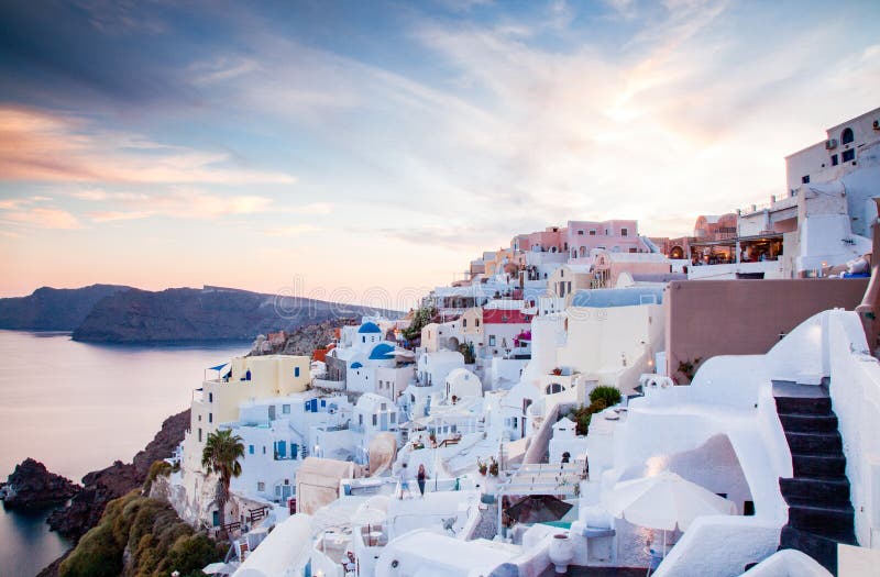 beautiful Oia town on Santorini island, Greece. Traditional white architecture and greek orthodox churches with blue domes over