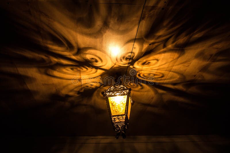 A beautiful old lantern gives beautiful shadows at night. Background. royalty free stock photos