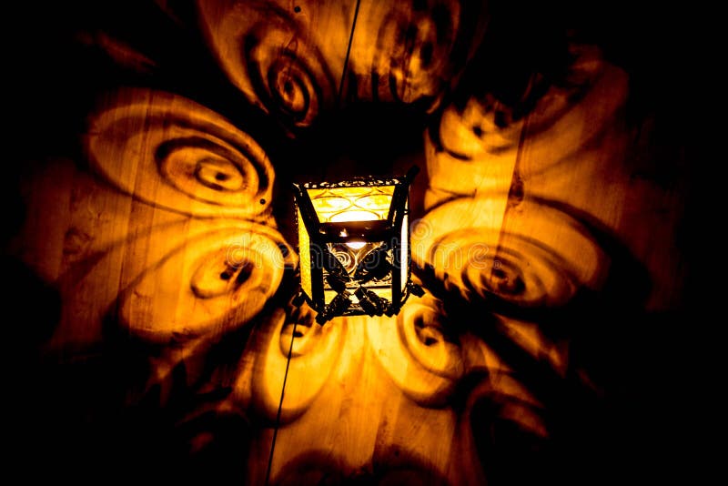 A beautiful old lantern gives beautiful shadows at night. Background. stock photography