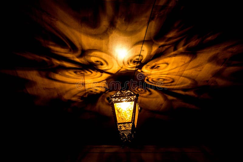 A beautiful old lantern gives beautiful shadows at night. Background. stock image