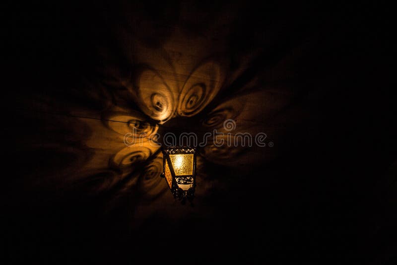 A beautiful old lantern gives beautiful shadows at night. Background. stock image