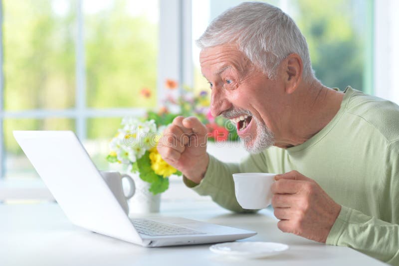 Beautiful old man with a laptop