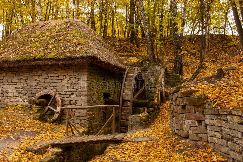 Beautiful old stone mill in the autumn season. Autumn landscape