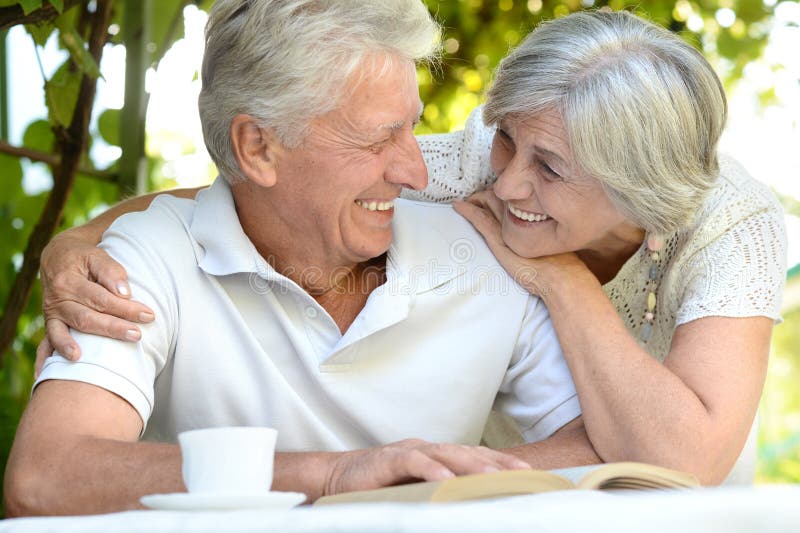 Beautiful older couple resting in the garden