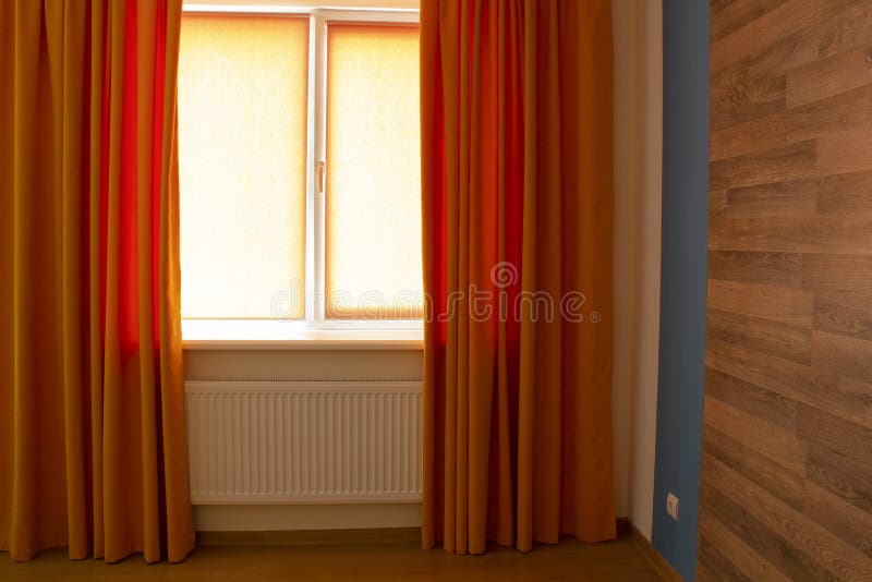 Beautiful Orange Curtains and Roller Blinds in an Apartment Stock Image