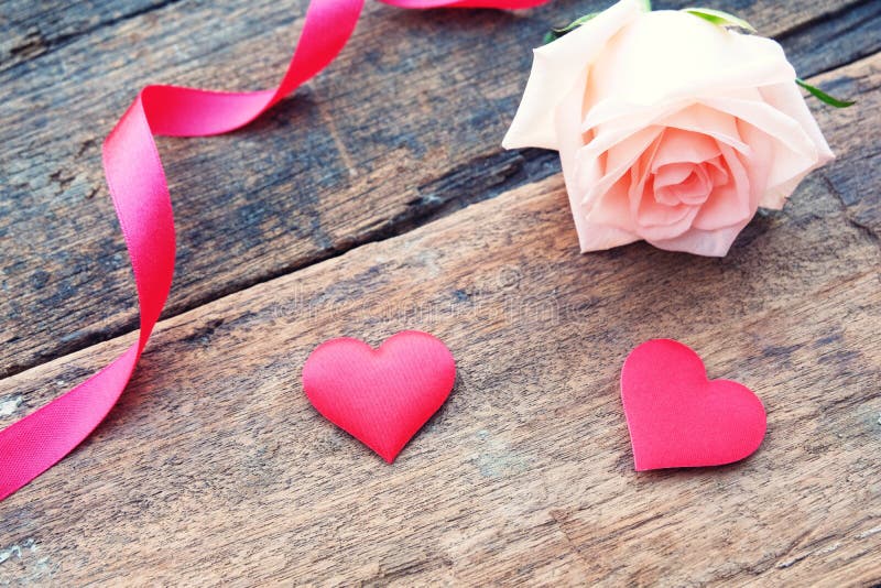 Beautiful Orange-Pink rose and deep red satin heart for Valentine& x27;s backdrop