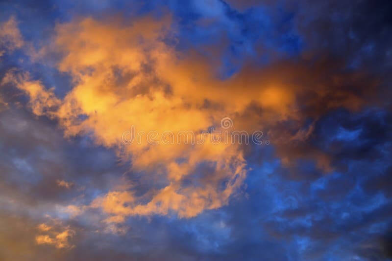Beautiful panorama of orange and yellow clouds at sunrise/sunset on a blue sky in high resolution royalty free stock photo Beautiful panorama of orange and yellow clouds at sunrise/sunset on a blue sky in high resolution royalty free stock photo