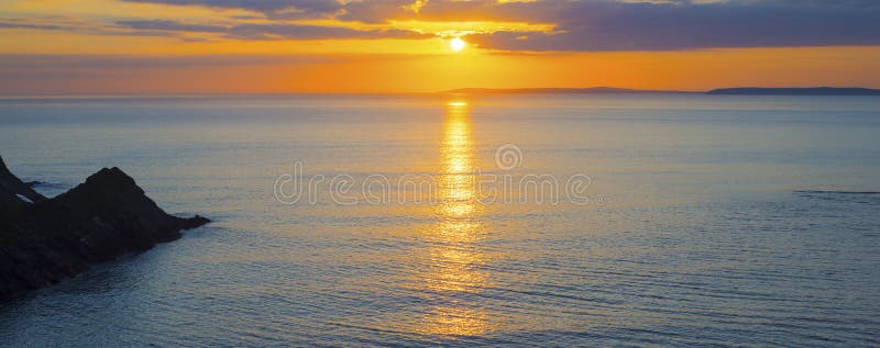 Beautiful panoramic yellow sunset over loop head