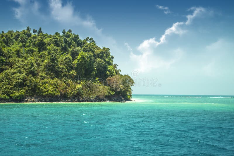 Beautiful paradise green island in the ocean. Tropics. Seascape with azure water and an island with many plants. Thailand Andaman Sea royalty free stock photo Beautiful paradise green island in the ocean. Tropics. Seascape with azure water and an island with many plants. Thailand Andaman Sea royalty free stock photo