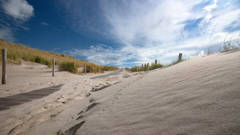 Impressive white and gray storm clouds over dune landscape along stock photos Impressive white and gray storm clouds over dune landscape along stock photos