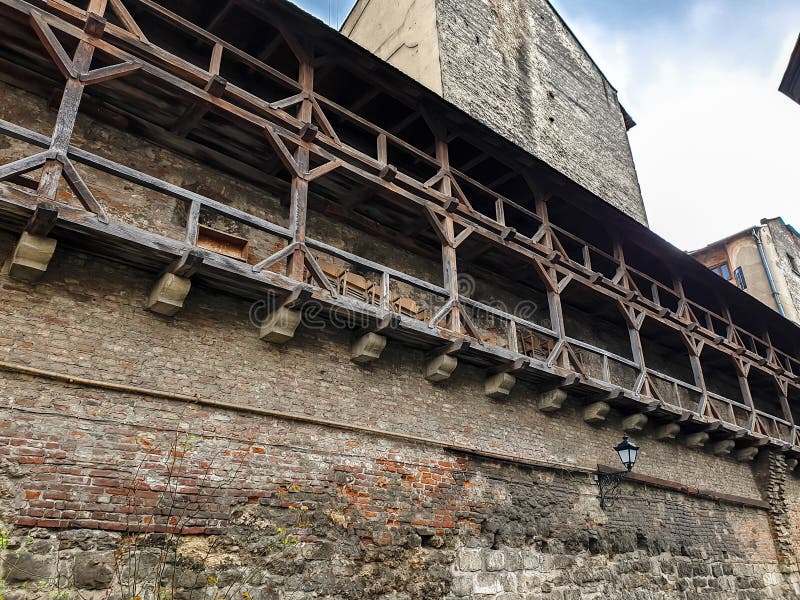 Beautiful image of ancient stone castle with long wooden gallery on walls royalty free stock image Beautiful image of ancient stone castle with long wooden gallery on walls royalty free stock image