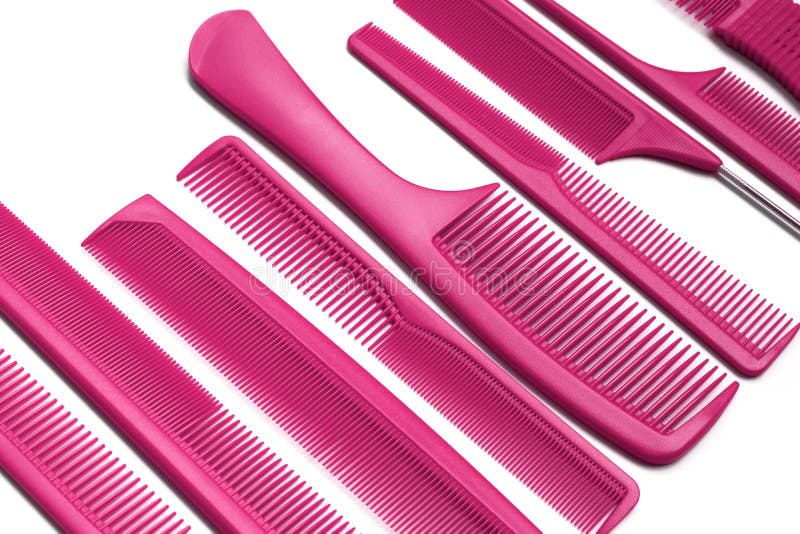 Beautiful pink bright combs for hairdressers on white background. Tools for beauty industry. Set of different hair brush. Beautiful pink bright combs for