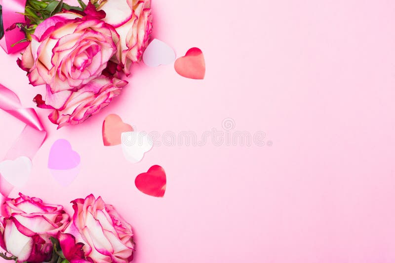 Beautiful pink rose, decorative confetti hearts and pink ribbon on pink Valentines day background stock photos Beautiful pink rose, decorative confetti hearts and pink ribbon on pink Valentines day background stock photos