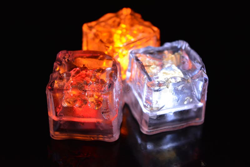 Beautiful plastic ice cubes with bright diode light. Red, yellow, white lighting for parties, recreation creative imagination.