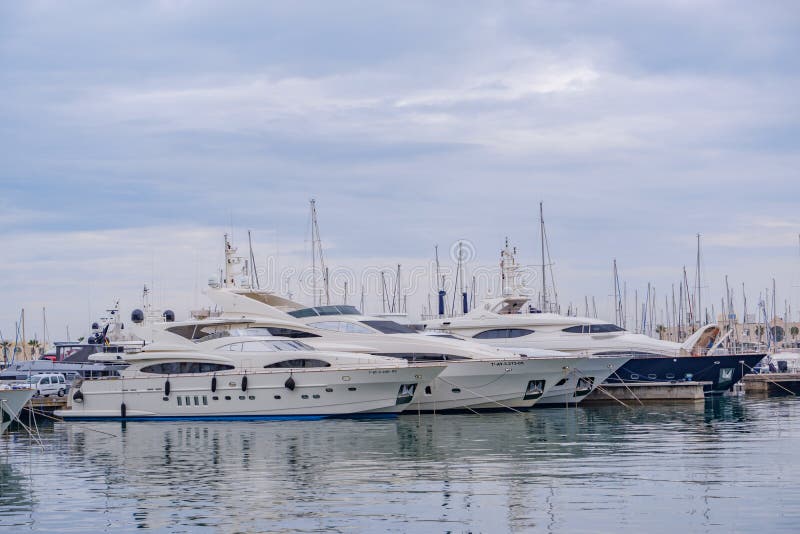 Beautiful port of Alicante, Spain Luxury yachts, ships, fishing boats sailing and standing in rows in harbor royalty free stock photos Beautiful port of Alicante, Spain Luxury yachts, ships, fishing boats sailing and standing in rows in harbor royalty free stock photos