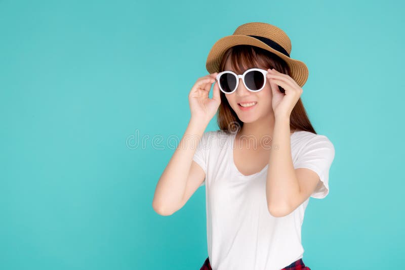 Beautiful portrait young asian woman wear hat and holding sunglasses smiling confident enjoy journey summer trip in vacation stock photo Beautiful portrait young asian woman wear hat and holding sunglasses smiling confident enjoy journey summer trip in vacation stock photo
