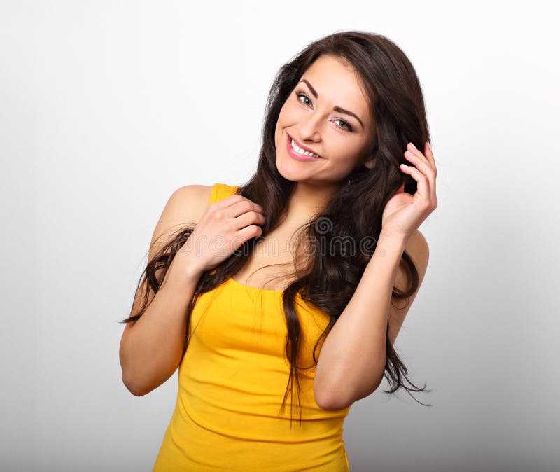 Beautiful positive happy woman in yellow shirt and long hair too