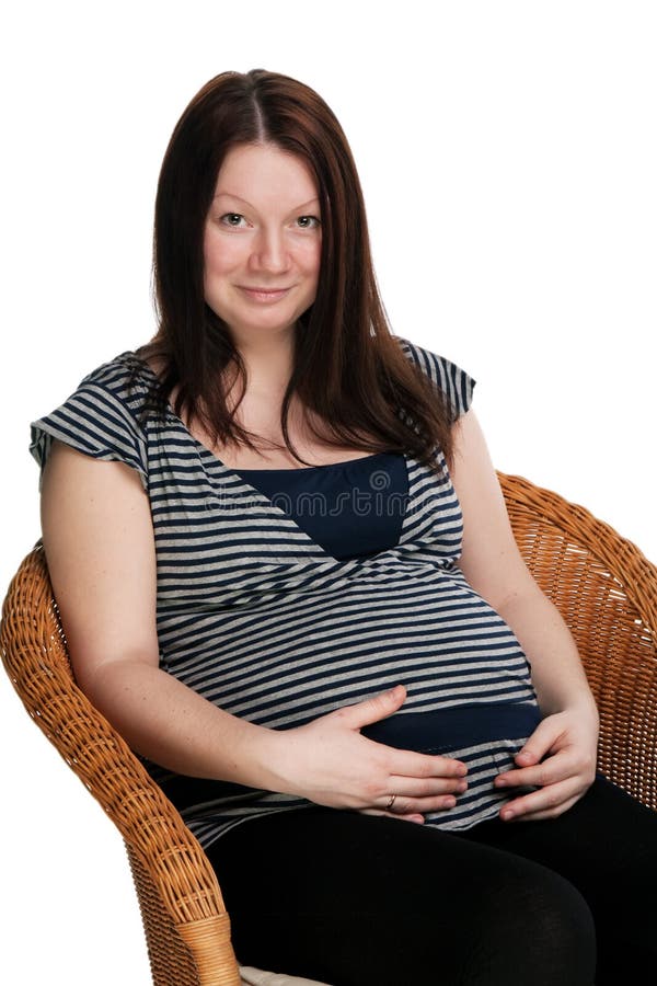 Beautiful pregnant girl sitting on chair